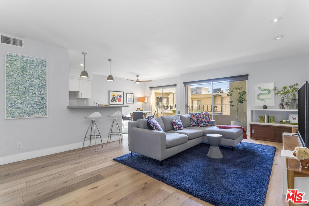 1221 North Kings Road, Unit 208 West Hollywood, CA 90069 - Photo 3 of 25 a living room with furniture and a wooden floor