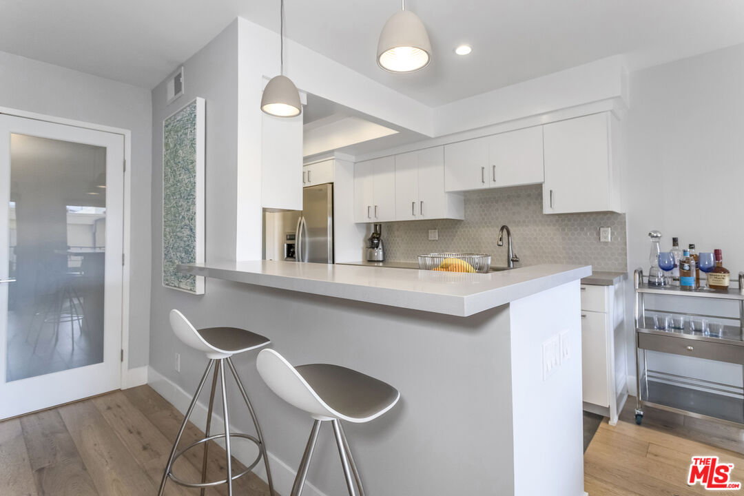 1221 North Kings Road, Unit 208 West Hollywood, CA 90069 - Photo 7 of 25 a kitchen with a sink cabinets and window