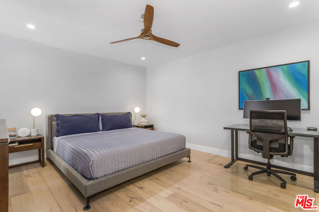 1221 North Kings Road, Unit 208 West Hollywood, CA 90069 - Photo 10 of 25 a bedroom with a bed a desk and chair