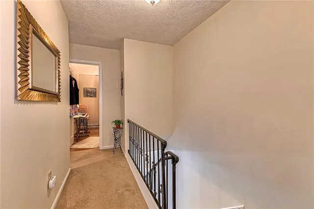 a view of a hallway with wooden floor and entryway
