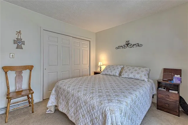 a bedroom with a bed a chair and couch