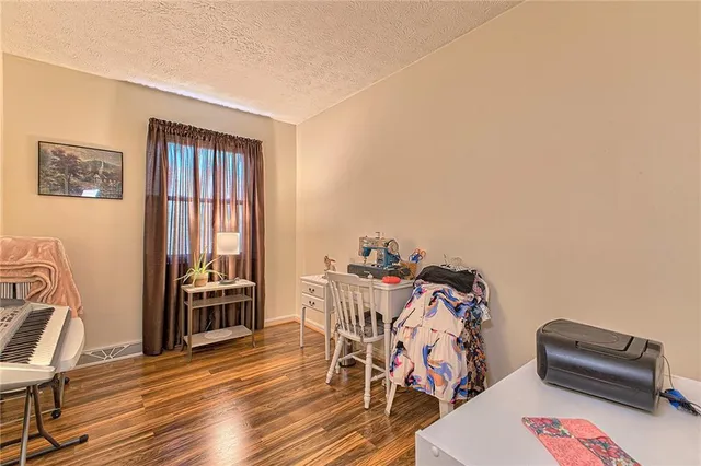 a view of a workspace with furniture and wooden floor