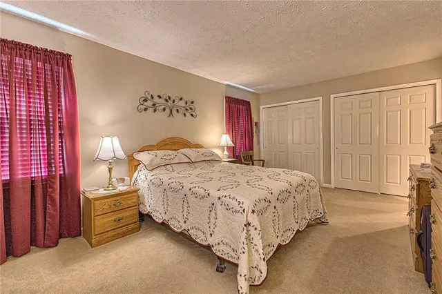 a bedroom with a bed and a night stand