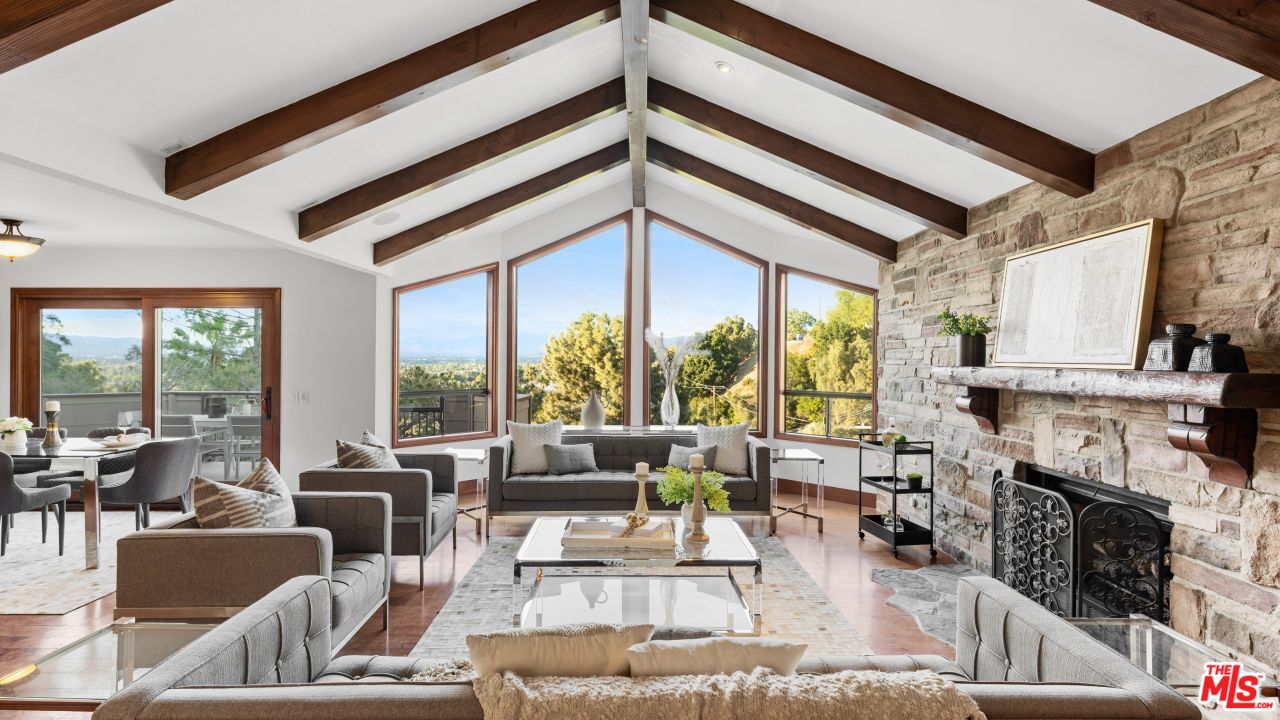 4117 Vanetta Place Studio City, CA 91604 - Photo 1 of 21 a living room with furniture a fireplace and large windows
