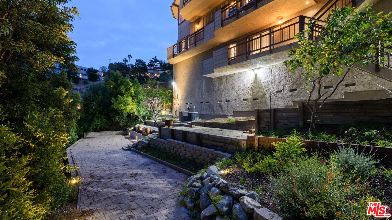 4117 Vanetta Place Studio City, CA 91604 - Photo 20 of 21 a backyard of a house with lots of green space and fountain