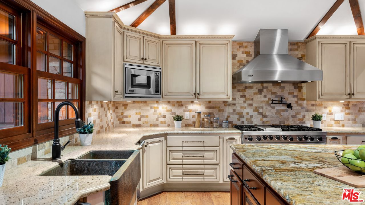 4117 Vanetta Place Studio City, CA 91604 - Photo 5 of 21 a kitchen with stainless steel appliances granite countertop a stove a sink and a microwave
