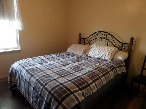 a bedroom with a bed and a window