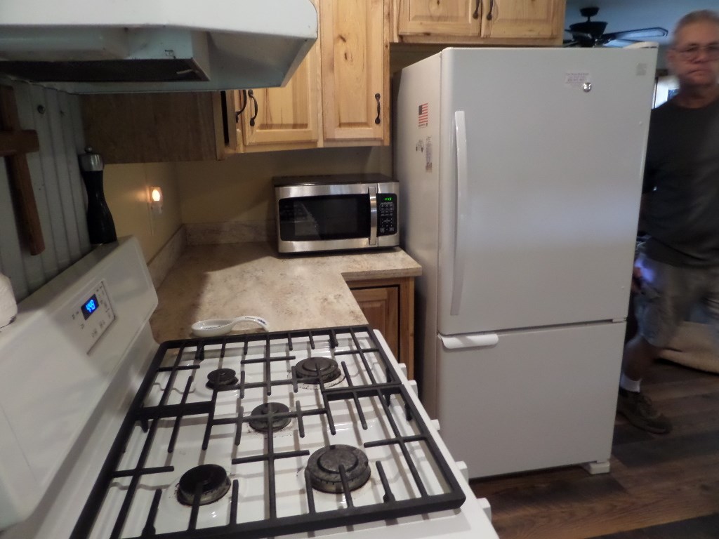 710 Elm Street Mason, TX 76856 - Photo 5 of 16 a kitchen with a refrigerator and a stove