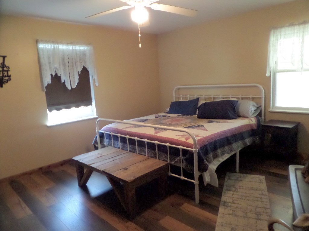 710 Elm Street Mason, TX 76856 - Photo 6 of 16 a bed sitting in a bedroom next to a window