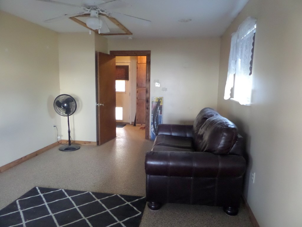 710 Elm Street Mason, TX 76856 - Photo 8 of 16 a living room with furniture and a chandelier