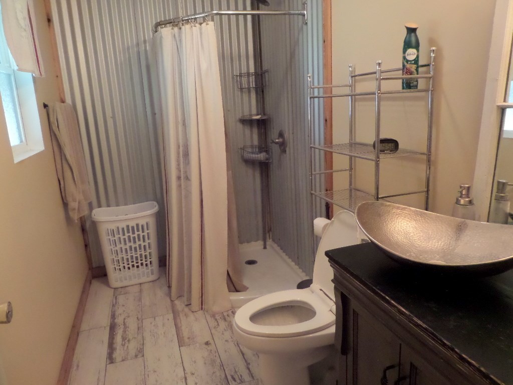 710 Elm Street Mason, TX 76856 - Photo 9 of 16 a bathroom with a sink a toilet and shower