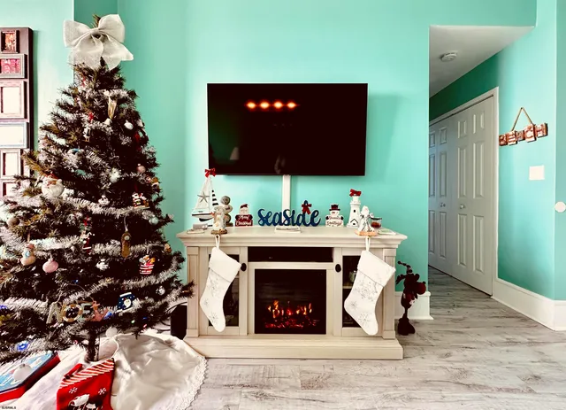 a living room with a fireplace wooden floor and a couch