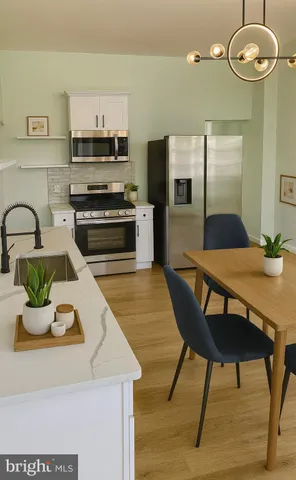 a kitchen with a table chairs and microwave