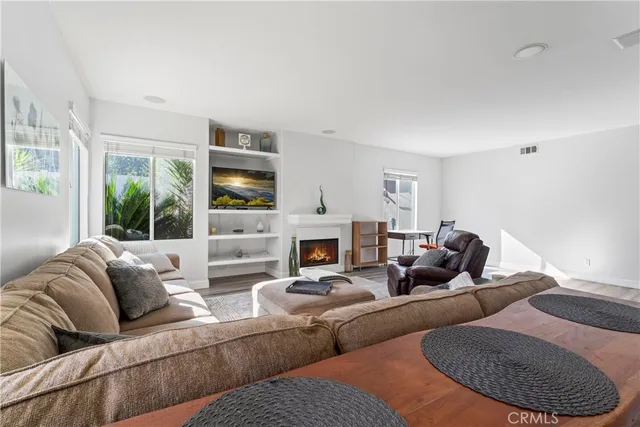 a living room with furniture fireplace and large window