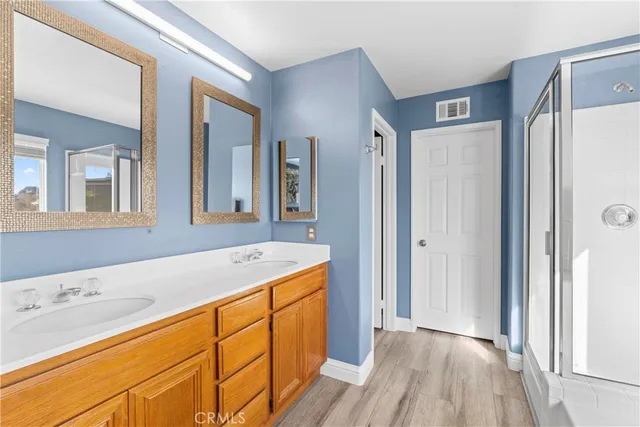a spacious bathroom with a granite countertop sink and a mirror
