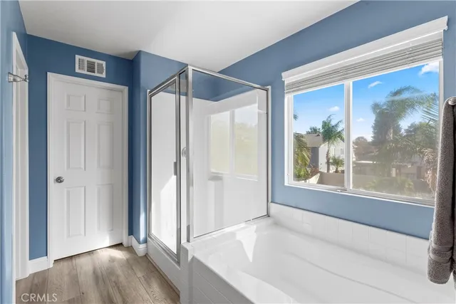 a spacious bathroom with a bathtub and a shower