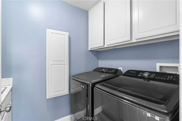 a kitchen with granite countertop a stove and a white cabinets