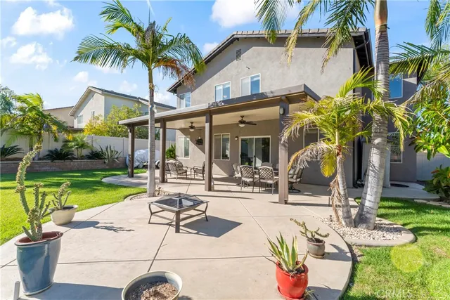 a view of a patio with couches chairs and swimming pool