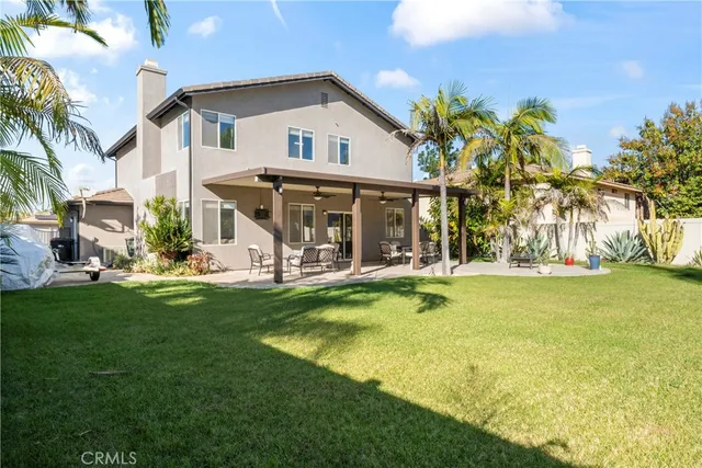 a view of a house with a swimming pool and sitting area
