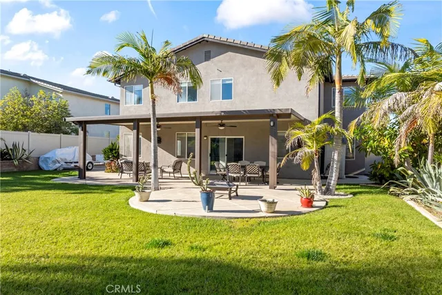 a view of a house with swimming pool and sitting area