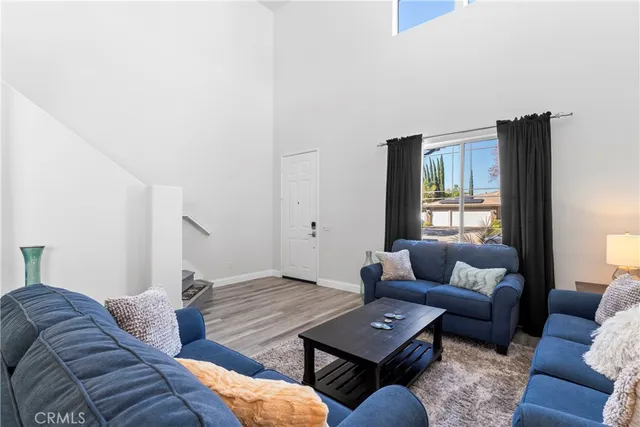 a living room with couches and a table with rug