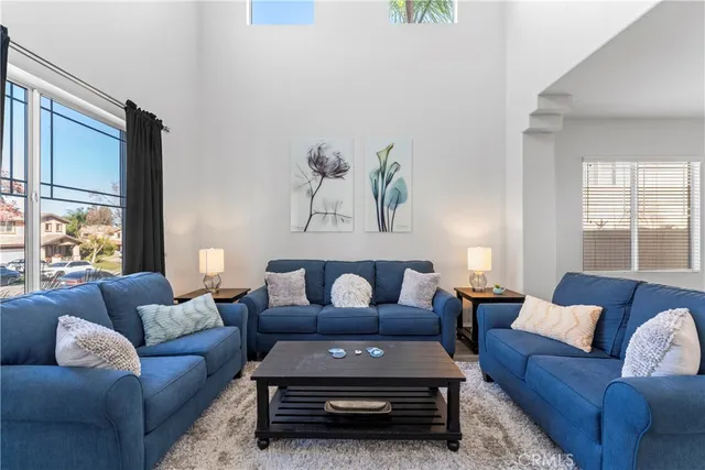 a living room with furniture a rug and a large window