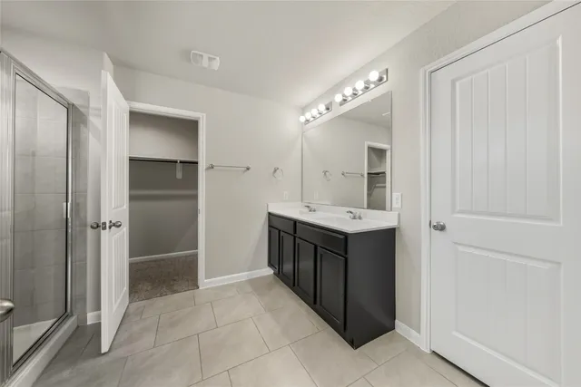 a bathroom with a double vanity sink and a mirror