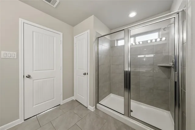a bathroom with a glass shower door