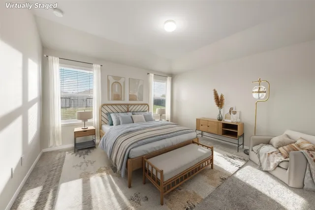 a bedroom with a bed and a large window