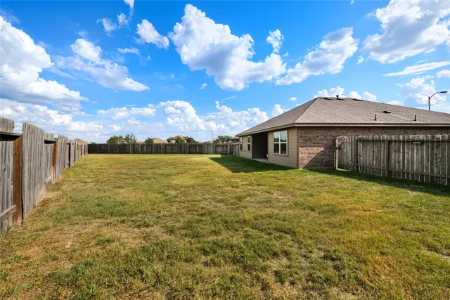 a view of a house with a backyard
