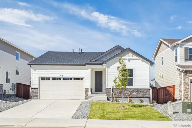 a view of house with backyard and outdoor seating