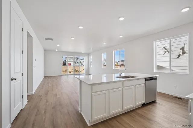 a kitchen with sink and cabinets
