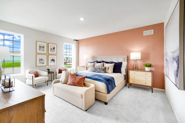 a spacious bedroom with a bed and a couch