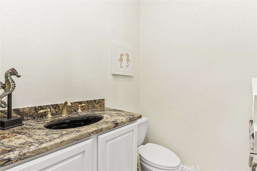 5233 Hampton Road Banning, CA 92220 - Photo 19 of 46 a bathroom with a granite countertop sink toilet and mirror