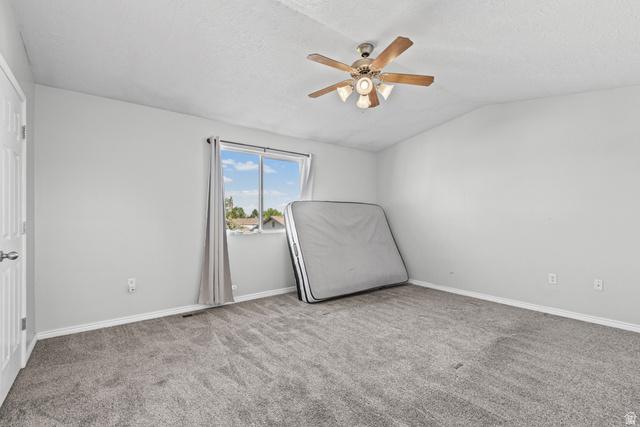 652 West 800 North, Unit 45 Clinton, UT 84015 - Photo 14 of 17 Carpeted room featuring a ceiling fan with integrated lighting, a window with curtains, and a paneled door