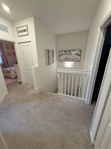 a view of a hallway with white walls