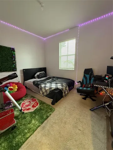 a bedroom with bed and a window