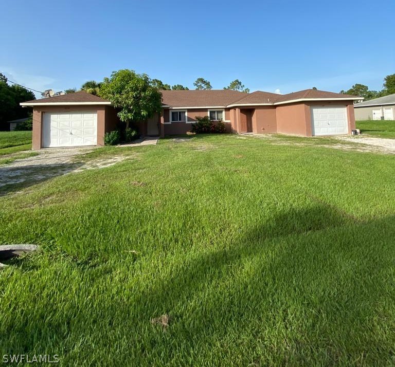 5128 30th Street Southwest Lehigh Acres, FL 33973 - Photo 1 of 6 a view of a house with a big yard