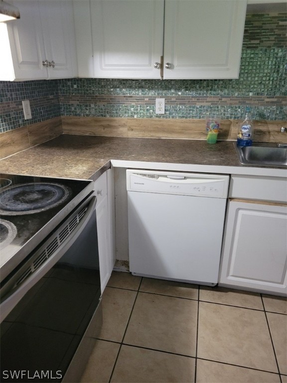 5128 30th Street Southwest Lehigh Acres, FL 33973 - Photo 2 of 6 a kitchen with a stove and cabinets