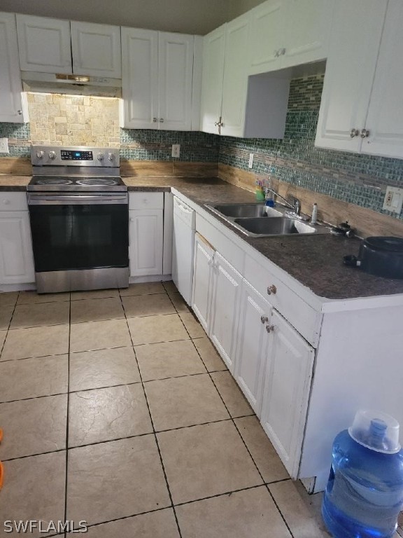 5128 30th Street Southwest Lehigh Acres, FL 33973 - Photo 3 of 6 a kitchen with stainless steel appliances a sink stove and cabinets