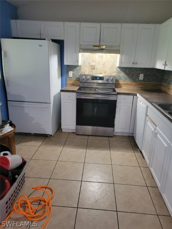 5128 30th Street Southwest Lehigh Acres, FL 33973 - Photo 5 of 6 a kitchen with a stove top oven and cabinets