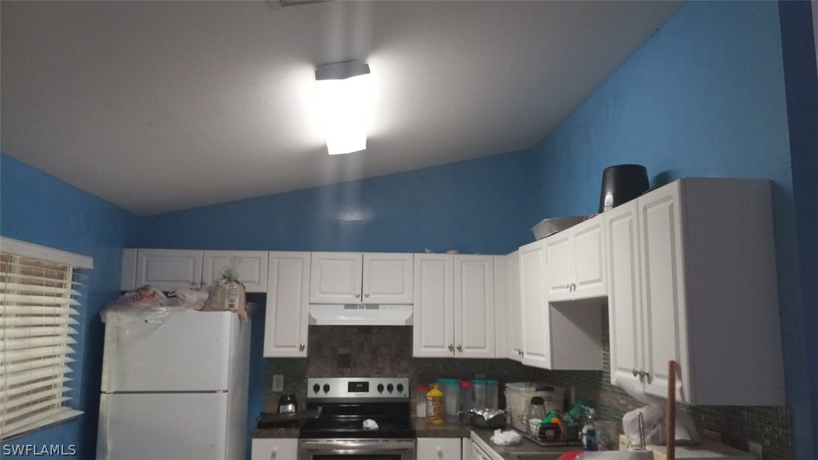 5128 30th Street Southwest Lehigh Acres, FL 33973 - Photo 6 of 6 a white refrigerator freezer sitting in a kitchen