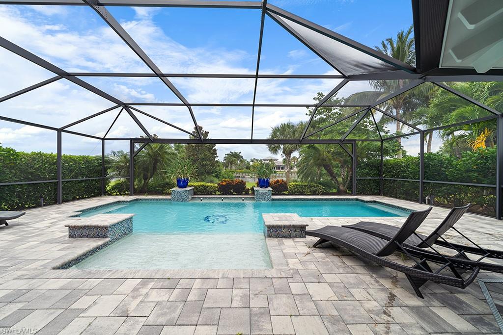 5154 Andros Drive Naples, FL 34113 - Photo 1 of 46 a view of a swimming pool with a patio