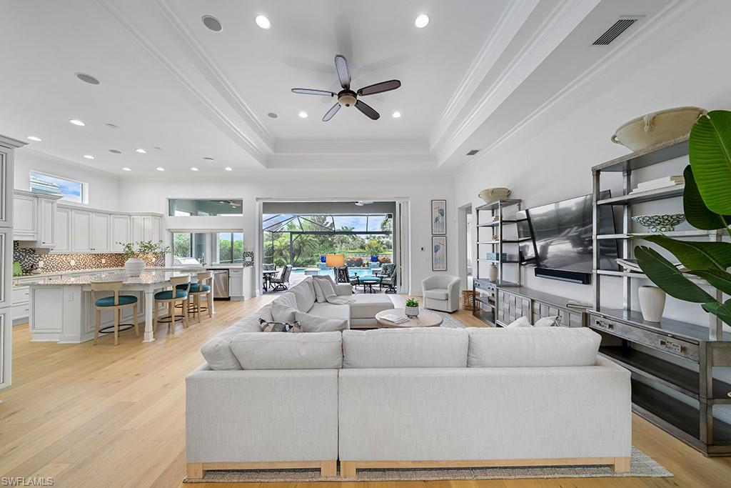 5154 Andros Drive Naples, FL 34113 - Photo 12 of 46 a living room with furniture and a flat screen tv