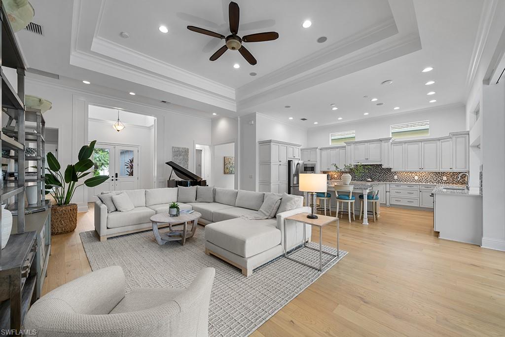 5154 Andros Drive Naples, FL 34113 - Photo 16 of 46 a living room with furniture kitchen view and a potted plant