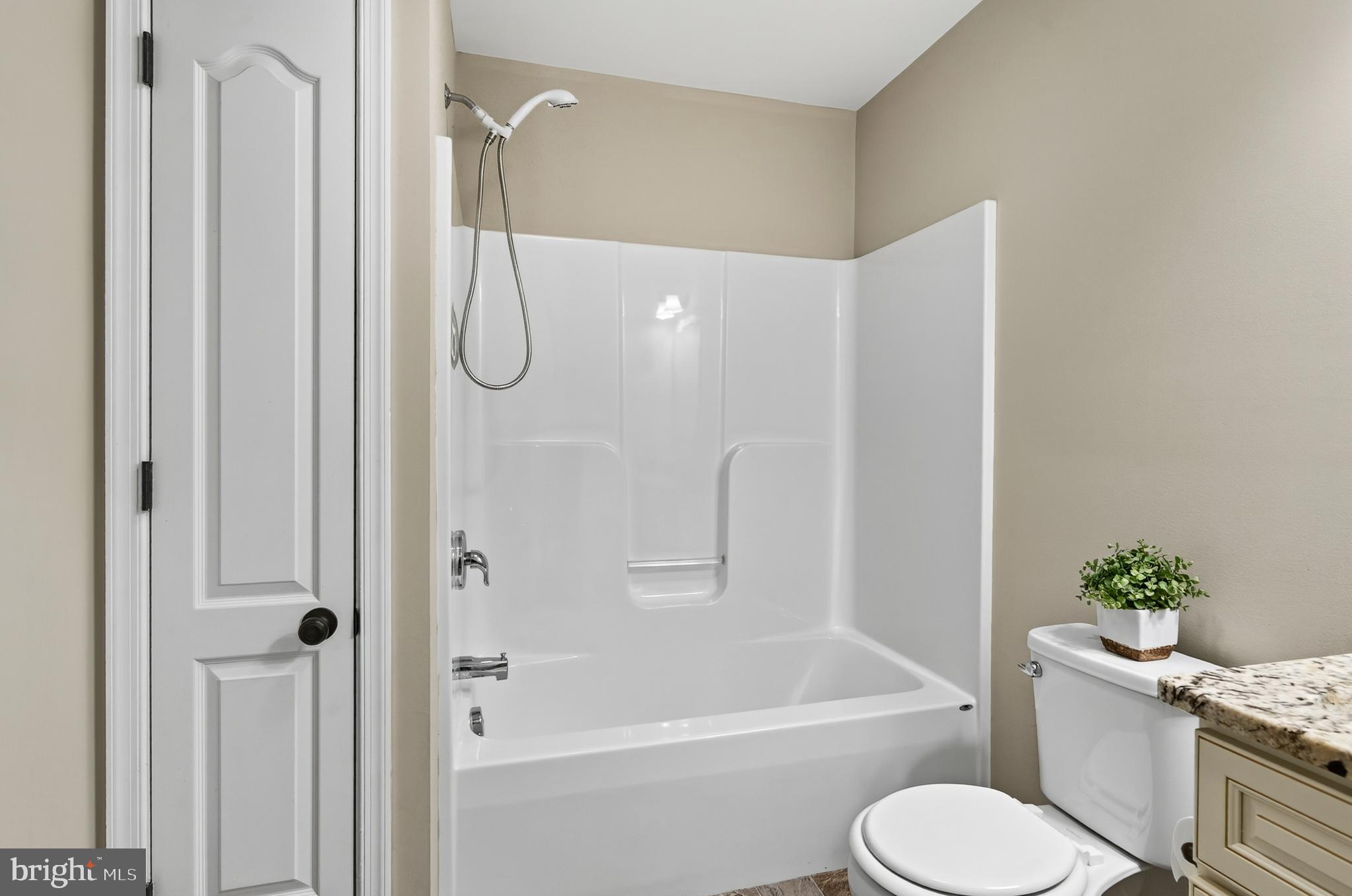 246 Oak Park Road Hatfield, PA 19440 - Photo 22 of 45 a bathroom with a granite countertop toilet a sink and a bathtub