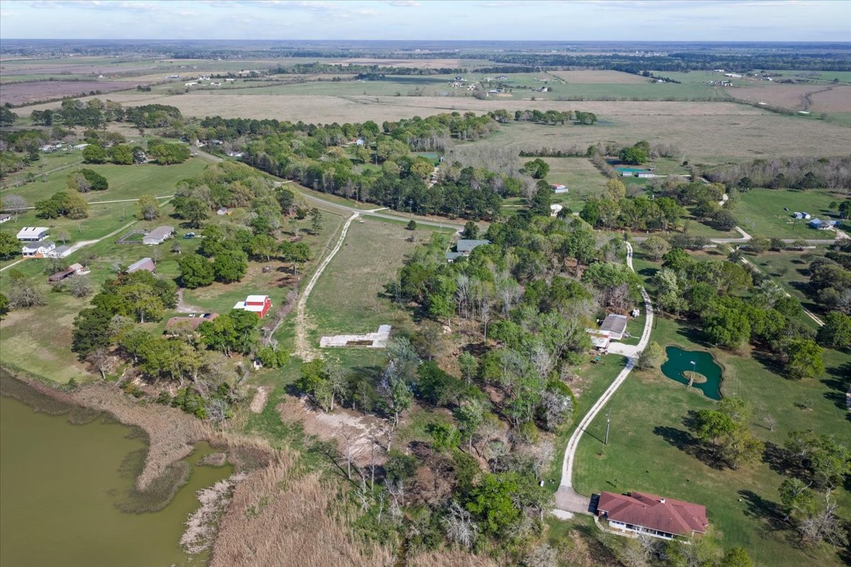 3514 South Main Street Anahuac, TX 77514 - Photo 7 of 14 an aerial view of a forest with houses