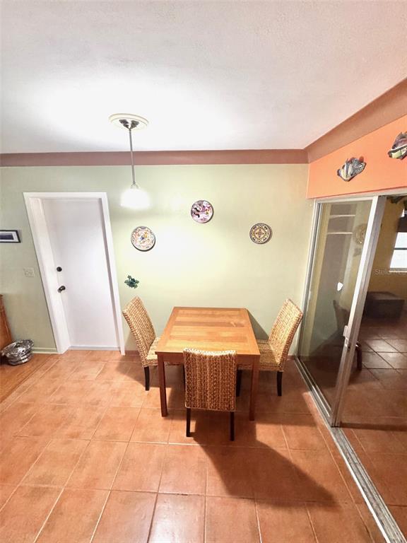 1035 Robmar Road Dunedin, FL 34698 - Photo 11 of 40 a living room with a table and chairs