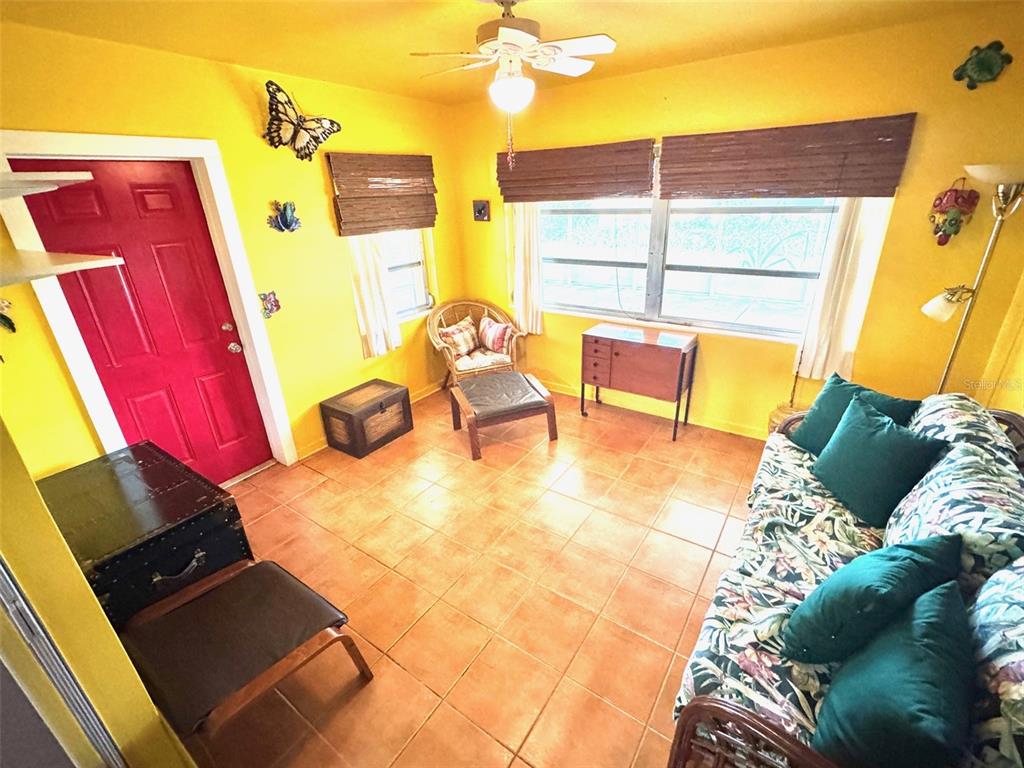 1035 Robmar Road Dunedin, FL 34698 - Photo 12 of 40 a view of a balcony with a couch and wooden floor