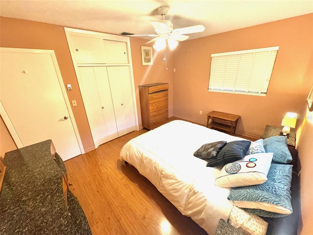 1035 Robmar Road Dunedin, FL 34698 - Photo 16 of 40 a bedroom with a bed and wooden floor